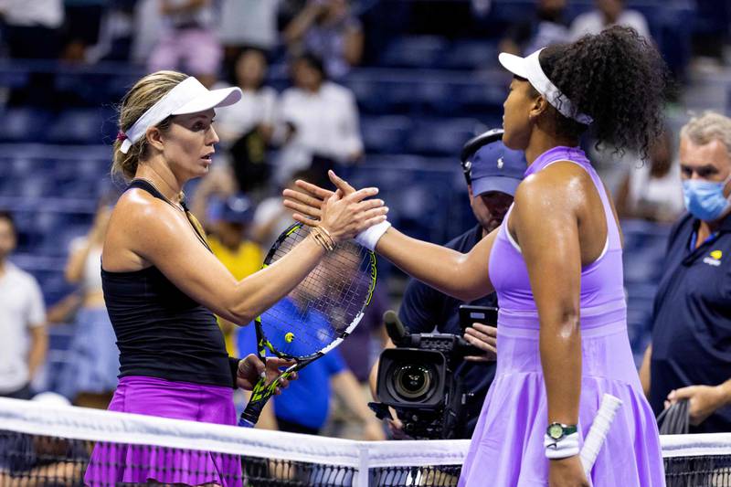 USA's Danielle Collins (L) and Japan's Naomi Osaka (R) greet each other at the net following their 2022 US Open Tennis tournament women's singles first round match at the USTA Billie Jean King National Tennis Center in New York, on August 30, 2022.  (Photo by COREY SIPKIN  /  AFP)