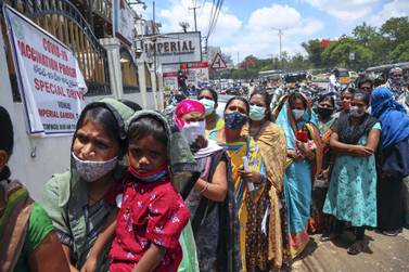 People queue up to get inoculated against the coronavirus during a special vaccination drive held for those working in various markets in Hyderabad, India, on June 6, 2021. AP Photo