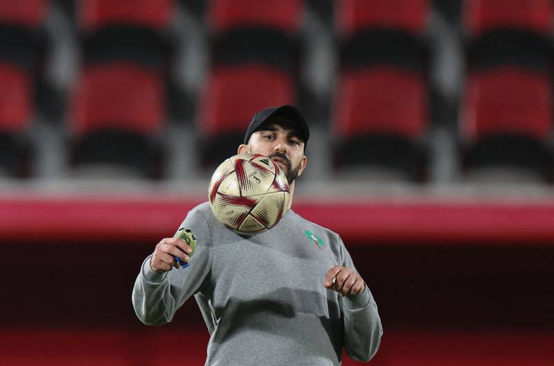 Morocco coach Walid Regragui juggles with a ball. AFP
