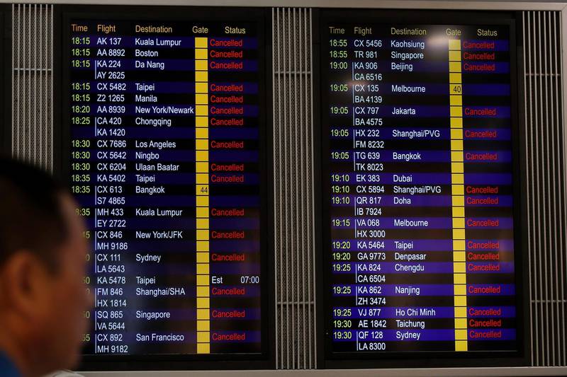 A man looks at the flight information board shows outbound flights was cancel at the Hong Kong International airport.  AP