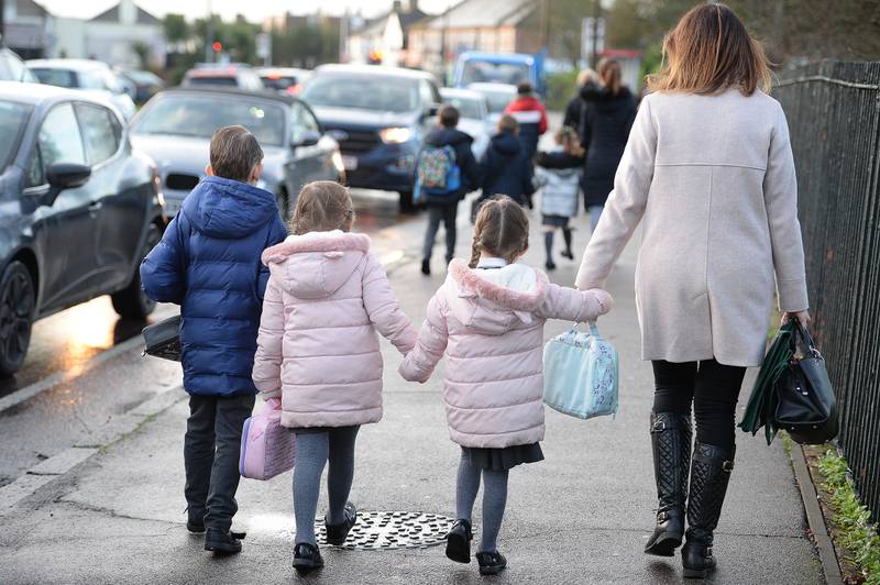 Parents walk their children to school in Hornchurch, Essex. PA
