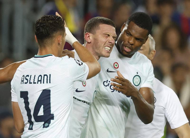 Inter Milan's Robin Gosens celebrates scoring their third goal with Denzel Dumfries and Kristjan Asllani. Reuters