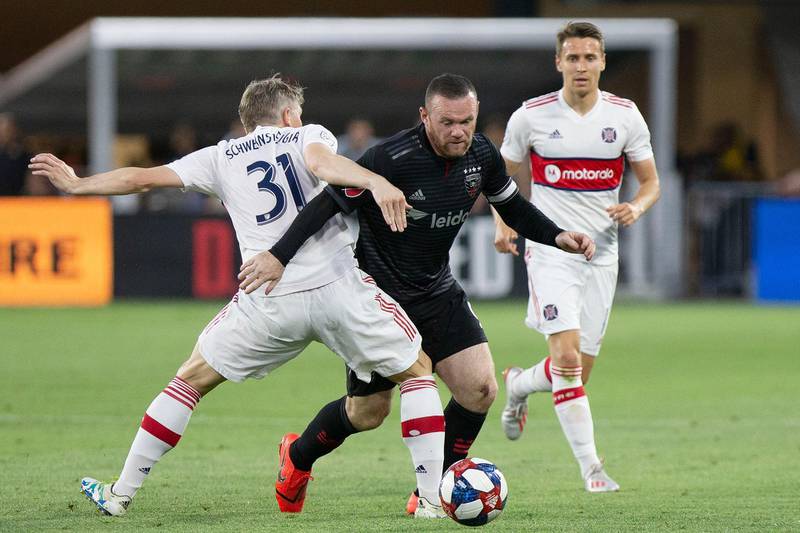 May 29, 2019; Washington, DC, USA; D.C. United forward Wayne Rooney (9) is fouled by Chicago Fire midfielder Bastian Schweinsteiger (31) while dribbling the ball in the first half at Audi Field. Mandatory Credit: Geoff Burke-USA TODAY Sports