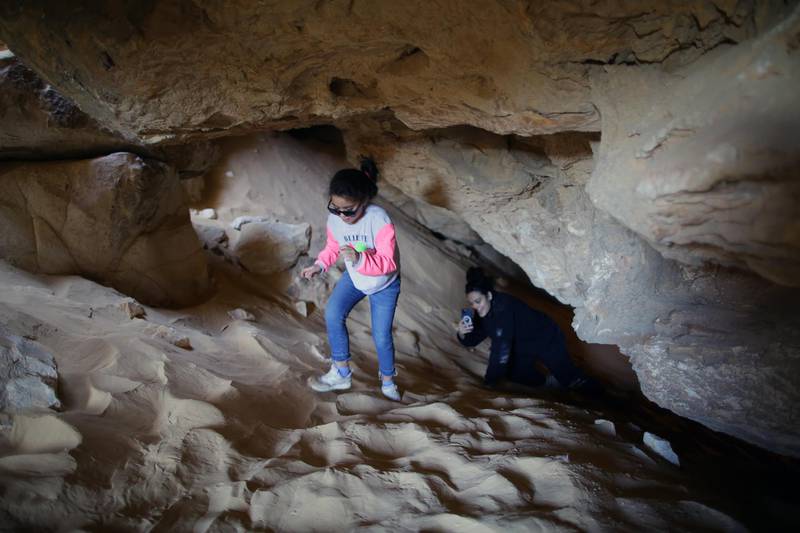 Tourists visit a cave on Maghrafa Mountain near Bawiti in Egypt. EPA