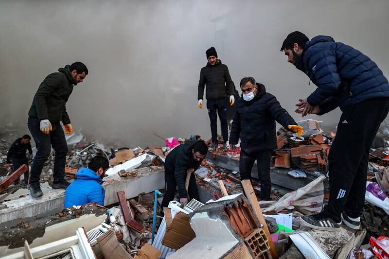 Rescuers search for survivors at the site of a collapsed building in Iskenderun. EPA