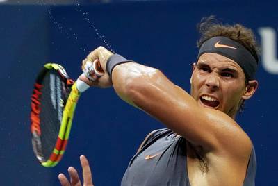 epaselect epa06977641 The sweat flies as Rafael Nadal of Spain returns a serve from David Ferer of Spain in Arthur Ashe Stadium during the first day of the US Open Tennis Championships the USTA National Tennis Center in Flushing Meadows, New York, USA, 27 August 2018. The US Open runs from 27 August through 09 September.  EPA/RAY STUBBLEBINE