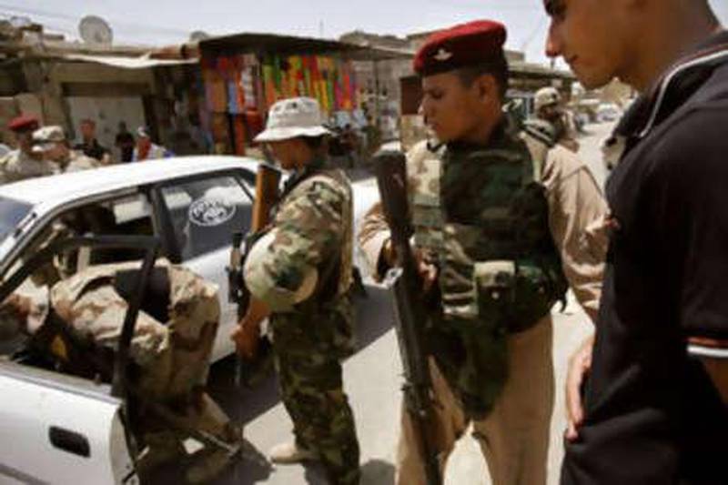 Iraqi soldiers and US marines stop a young man who was driving erratically through a crowded marketplace in the troubled Basra neighbourhood of Hayaniya.