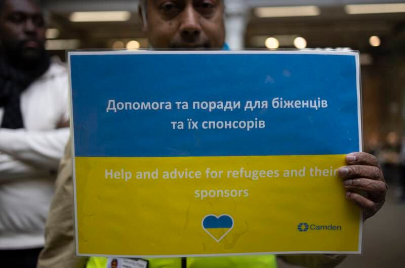 Workers at a 'welcome hub' for arriving Ukrainians wait to guide people at St Pancras station in London, England. Getty Images