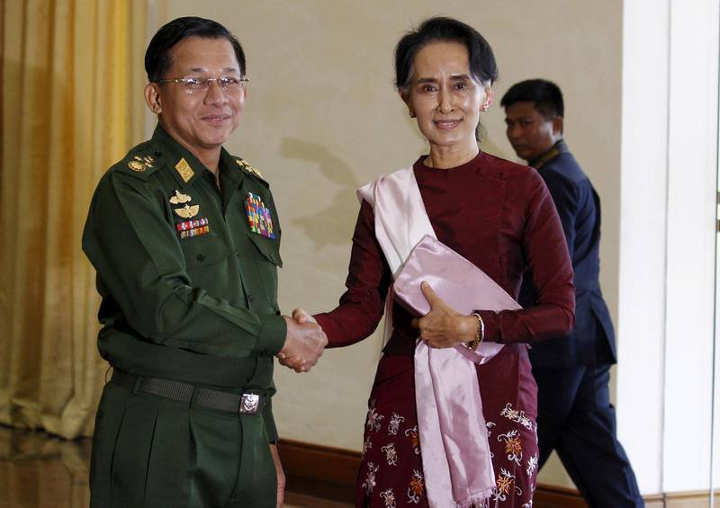 FILE PHOTO: Myanmar's Commander-in-Chief Min Aung Hlaing (L) shakes hands with National League for Democracy (NLD) party leader Aung San Suu Kyi before their meeting in Naypyitaw December 2, 2015. REUTERS/Soe Zeya Tun/File Photo