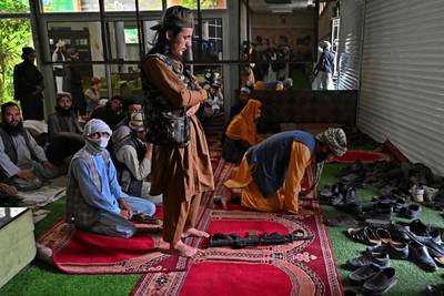Taliban fighters offer noon payers inside the home of Afghan warlord Abdul Rashid Dostum in the Sherpur neighbourhood of Kabul. AFP