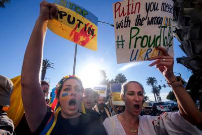 Demonstrators carry flags during a rally in support of Ukraine in Santa Monica, California. AFP