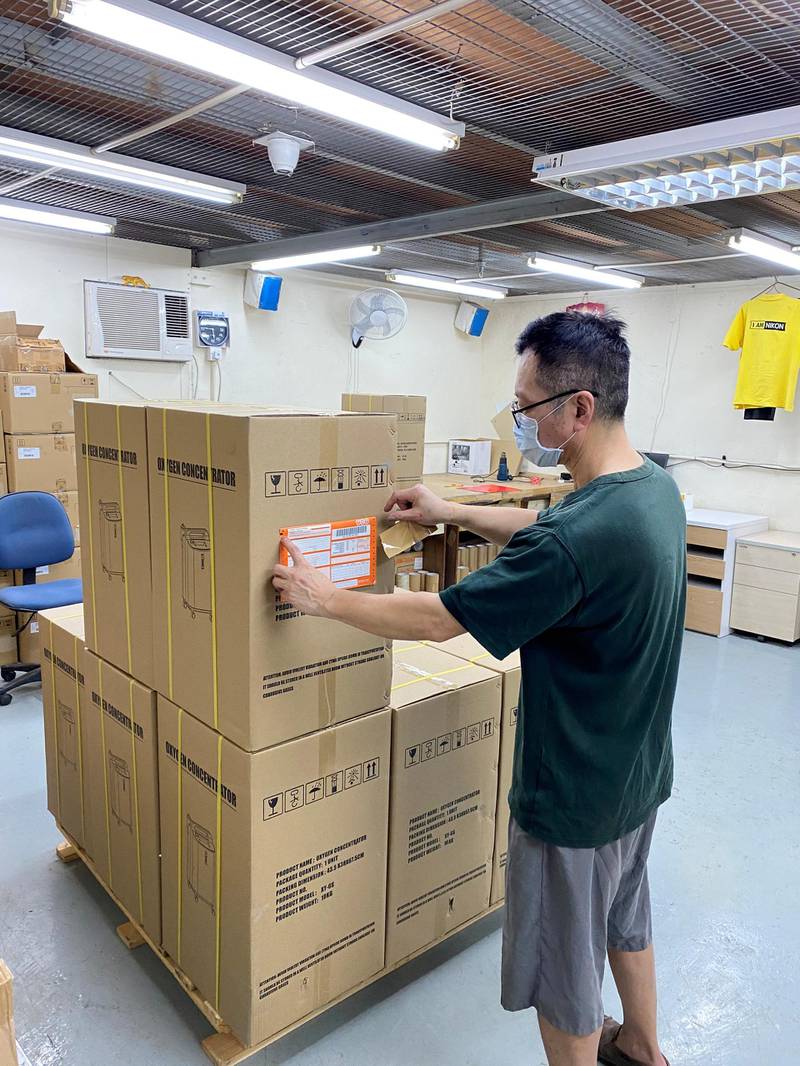 A worker packs oxygen concentrators, a device that extracts oxygen from the air to help Covid-19 patients breathe, in a warehouse in Hong Kong. Shipments of the machines to India has risen as people are forced to rely on home care of patients with hospitals turning away patients. courtesy Jacky’s Electronics