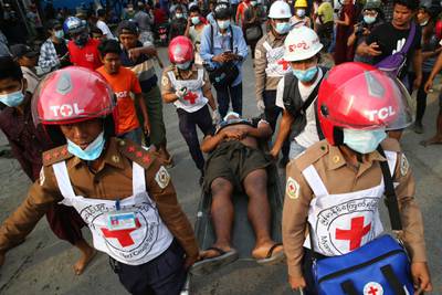 Red Cross workers carry a man on a stretcher in Mandalay, Myanmar. AP
