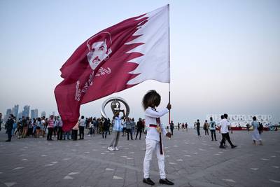 A Qatar fan waves the national flag. AFP