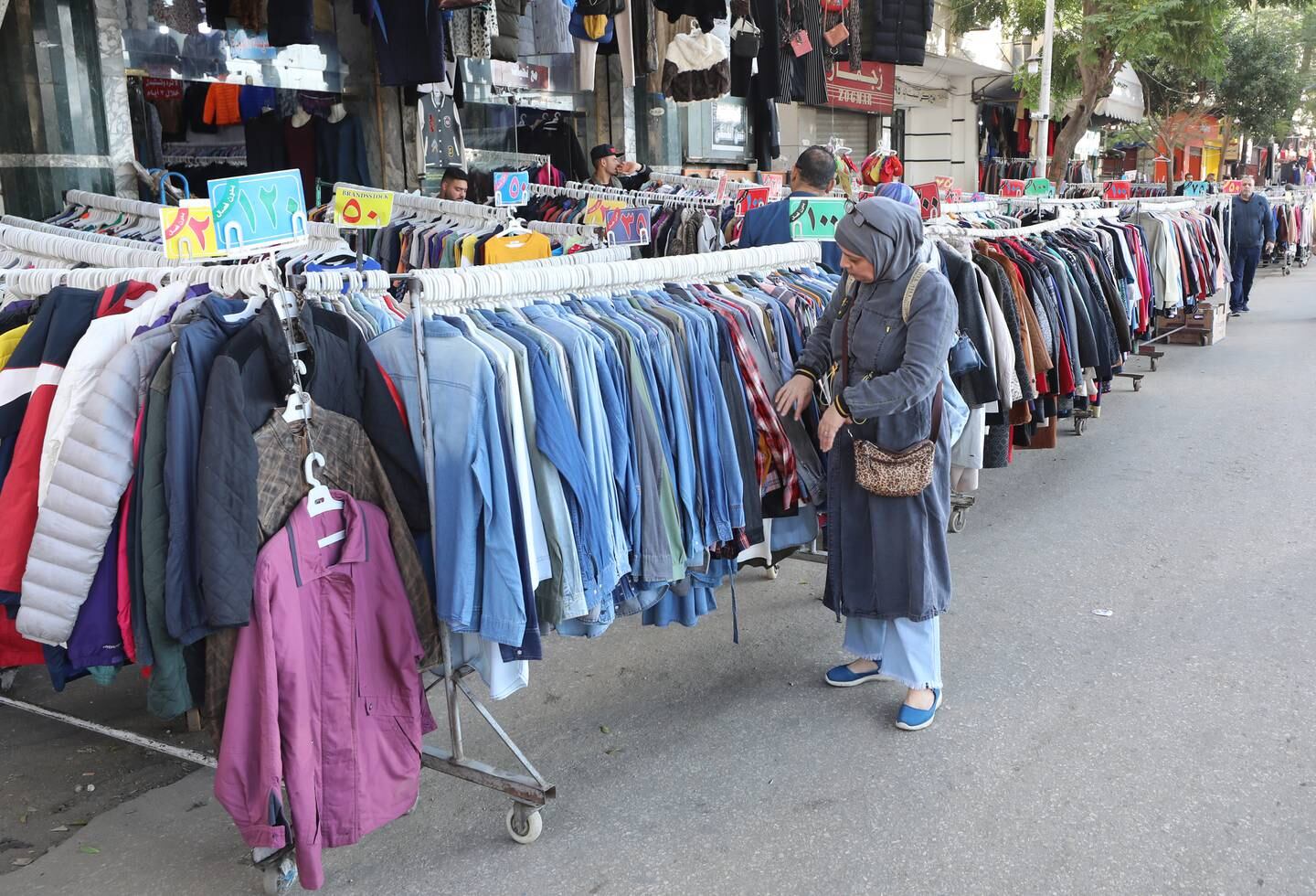 A shopper at an outdoor clothes market in the Bulaq district in Cairo, Egypt. EPA