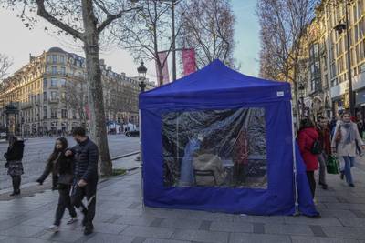 A medical technician administers nasal swabs at a mobile testing site in Paris. AP Photo