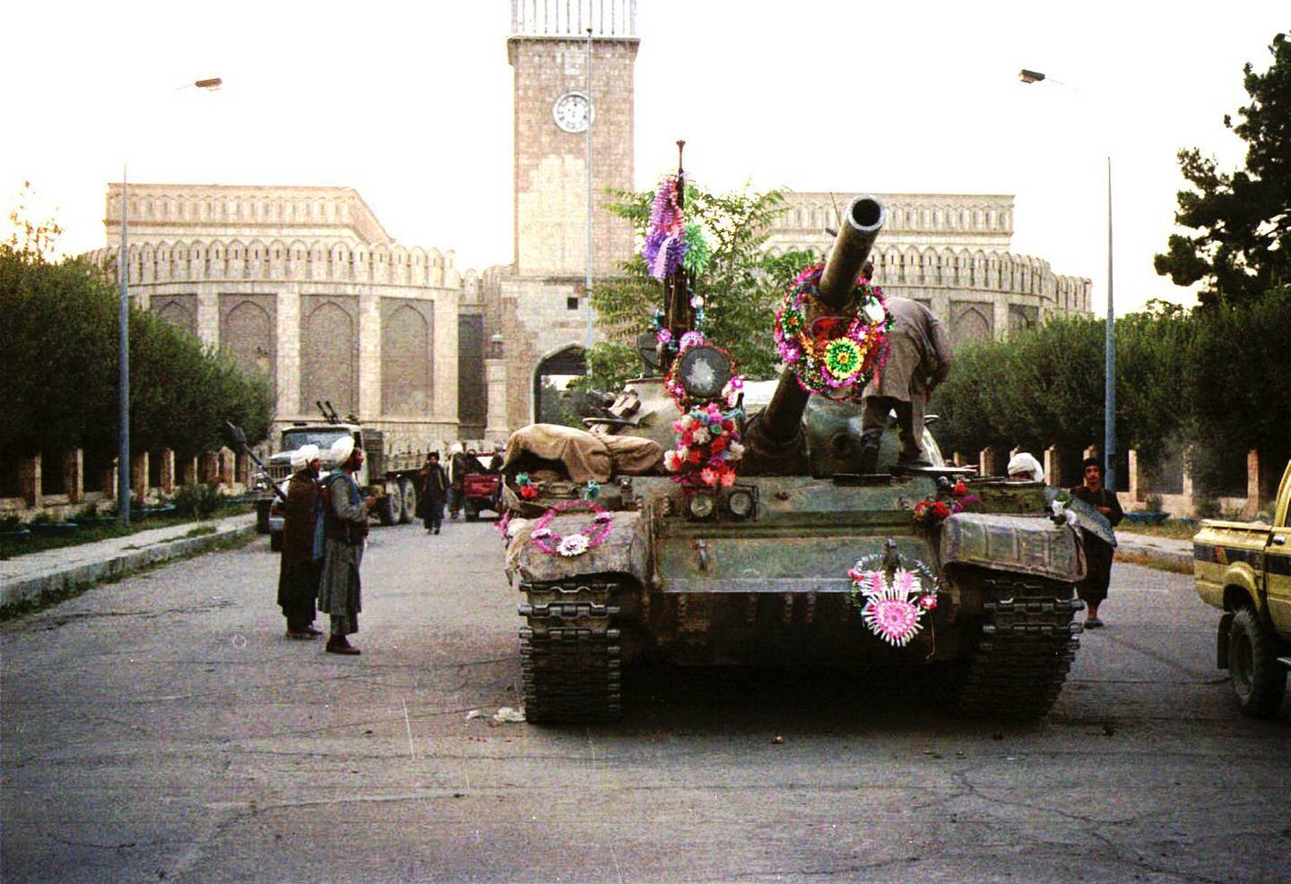 Tanks manned by Taliban fighters parade in front of the the damaged Presidential Palace in Kabul, Afghanistan, in 1996. AP
