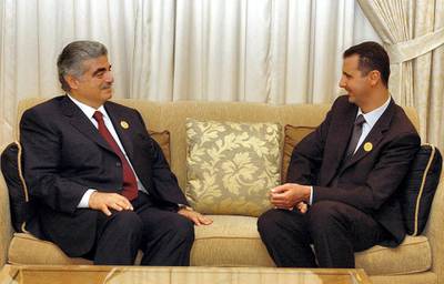Lebanese Prime Minister Rafiq Hariri (L) meets with Syrian President Bashar al-Assad on the sidelines of the Arab summit in Beirut 27 March 2002. Hariri announced that the Palestinians would rejoin the summit 28 March after pulling out over Lebanon's refusal to allow Palestinian leader Yasser Arafat to address the meeting by satellite link.       AFP PHOTO/Ayman TRAWI/HO (Photo by AYMAN TRAWI / LEBANESE PRIME MINISTER'S OFFICE / AFP)