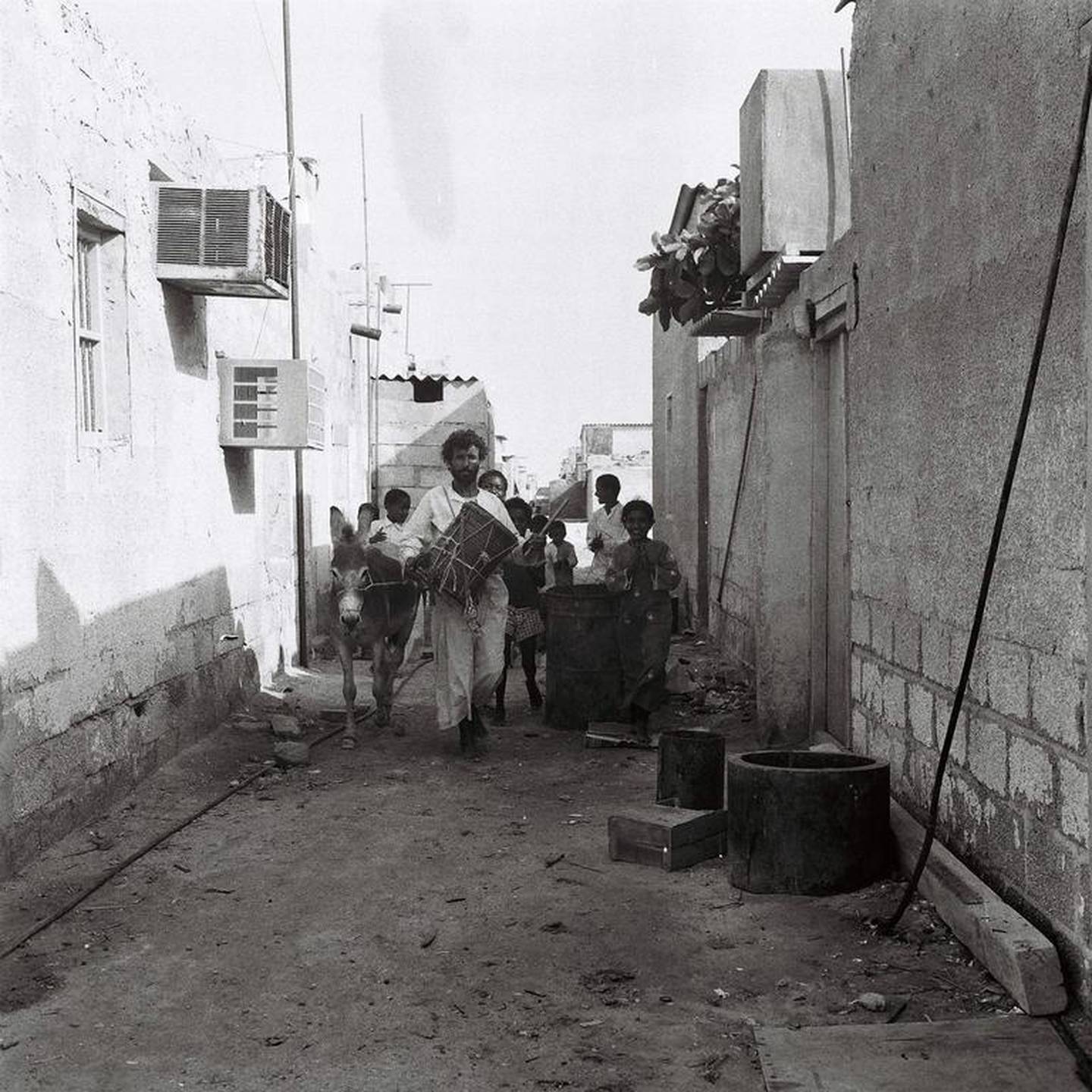 Drummer Khamees Abu Tubaila and his entourage walk the alleyways of Abu Dhabi to wake people and prepare them for the day’s fasting. Courtesy Alettihad
