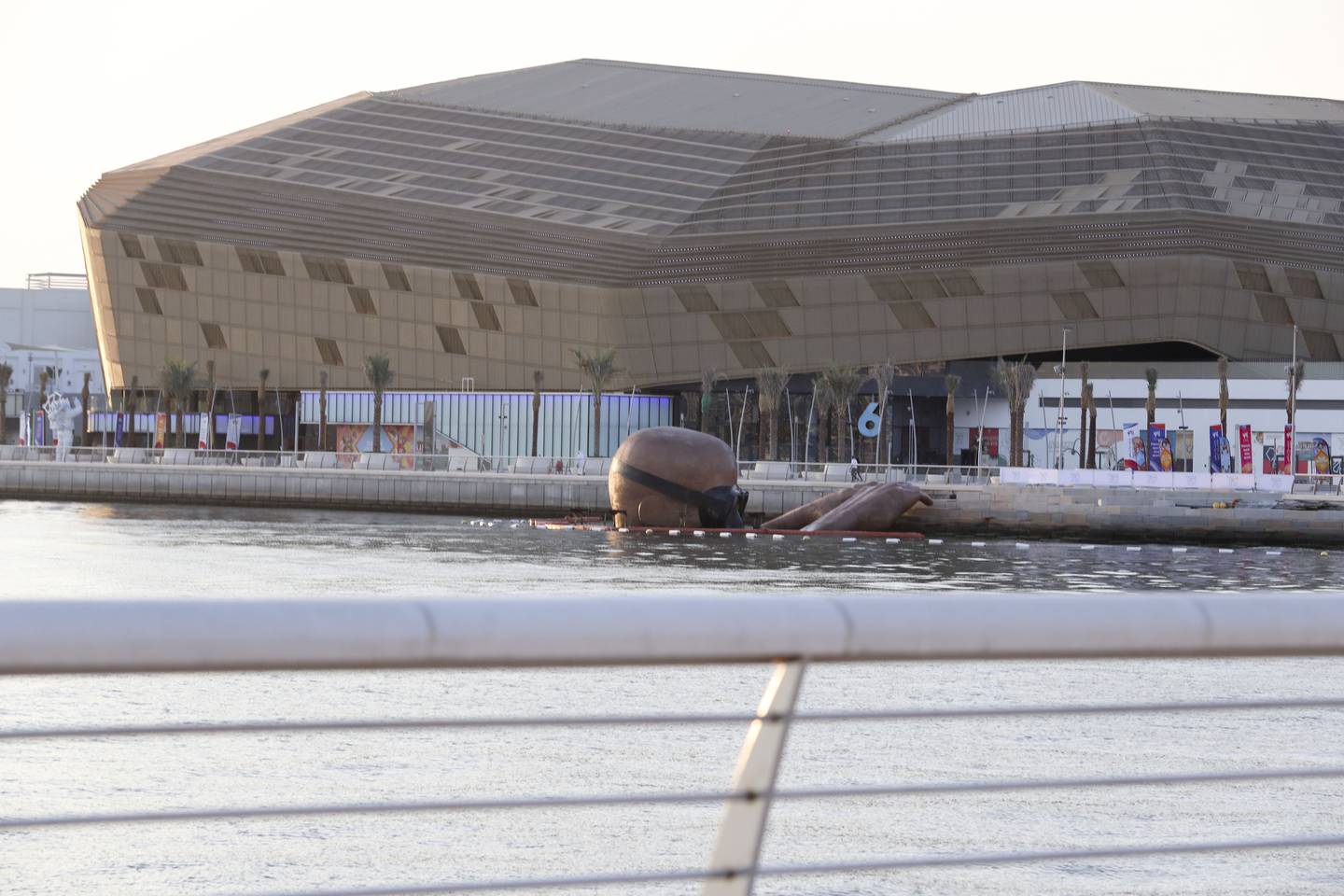 A giant bronze sculpture emerges from the water at Yas Bay Waterfront.  Khushnum Bhandari / The National 
