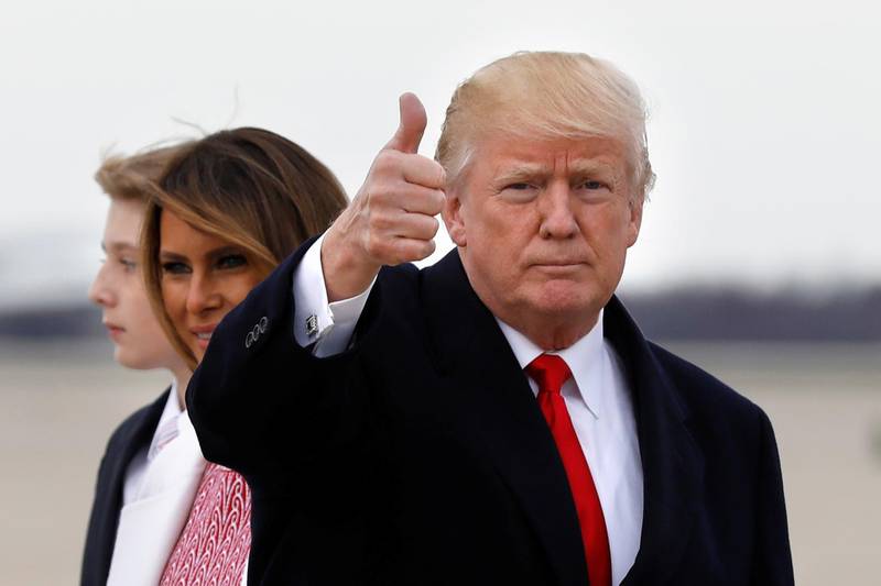 U.S. President Donald Trump gestures to the media as he arrives with first lady Melania Trump and their son Barron at Joint Base Andrews in Maryland, U.S., after the Easter weekend in Palm Beach, Florida, April 1, 2018. REUTERS/Yuri Gripas