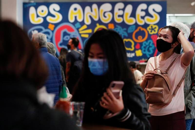 People wear face masks inside Grand Central Market in Los Angeles. EPA