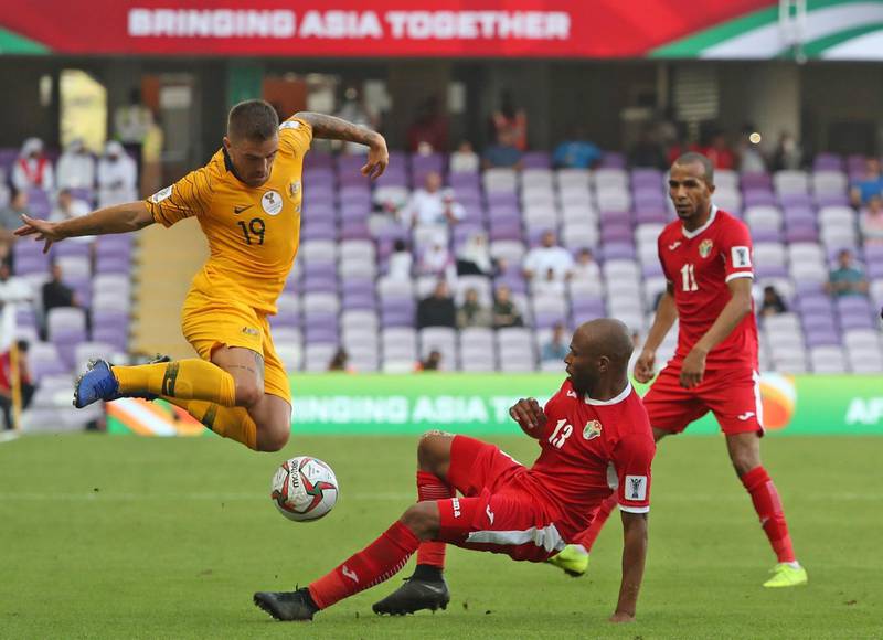 Jordan midfielder Khalil Bani Ateyah, right, tackles Australia's defender Joshua Risdon. AFP