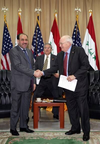 Prime minister Nouri Al Maliki shakes hands with US vice president Dick Cheney as a translator looks on during a meeting in Baghdad on May 9, 2007.