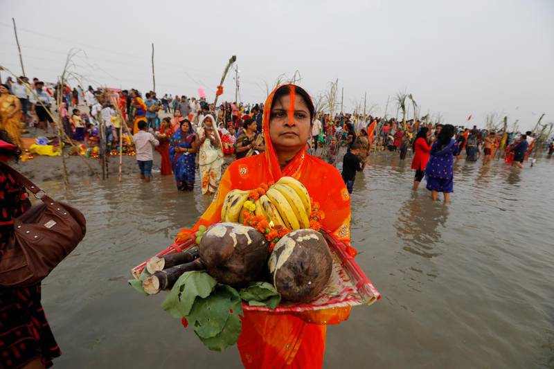 Hindu devotees perform rituals dedicated to the sun god on Chhat Puja festival in Prayagraj, India. Health officials have warned about the potential for the coronavirus to spread during the upcoming religious festival season. AP Photo