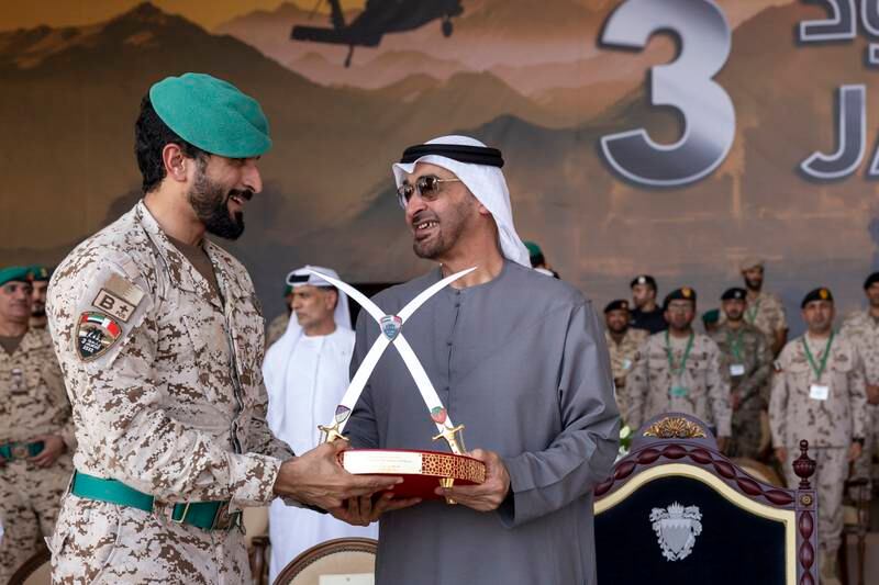 Sheikh Mohamed is presented with a gift by Maj Gen Sheikh Nasser.
