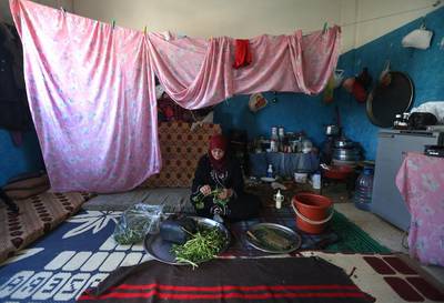 Syrian refugee woman Ruwaida al-Ahmad, 45, prepares to cook grass at a school-turned shelter in Wadi Khaled at the Lebanese-Syrian border village of Al Rama, north Lebanon. Hussein Malla/AP Photo