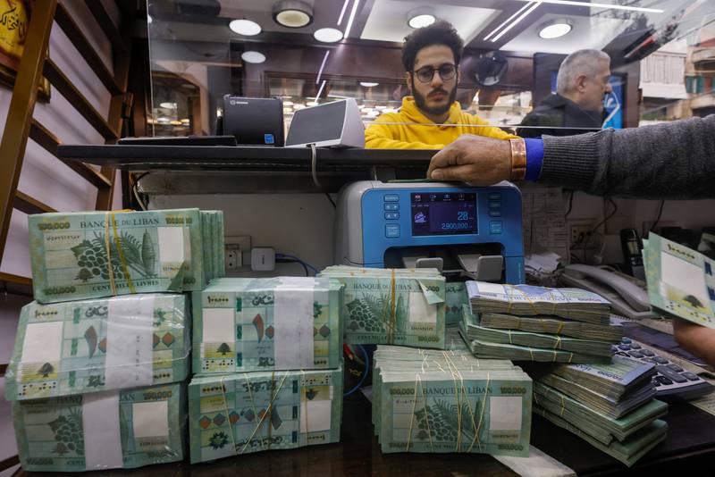 A man counts Lebanese banknotes at an exchange shop in Beirut. Most of them were shut on Thursday. Reuters