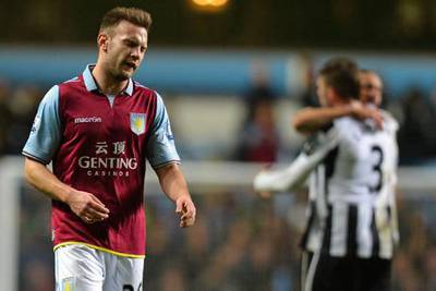Aston Villa's Andreas Weimann shows the strain as Newcastle celebrate their victory.