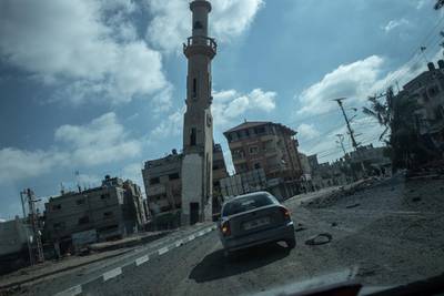 A car drives through rubble, after an Israeli raid in northern Gaza City. Getty Images