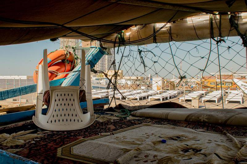 Hundreds of fishermen in Abu Dhabi's Mina Ziyad have returned home after restrictions on fishing have made it hard to make a living. Each boat in the port is occupied by four to five men who would come up to the decks to rest