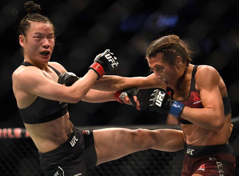 Weili Zhang takes a punch form Joanna Jedrzejczyk while attempting to land a kick. AFP