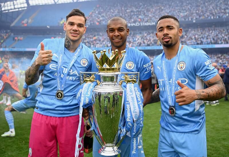 Ederson, Fernandinho and Gabriel Jesus pose with the Premier League trophy. Getty