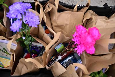 A welcome pack containing flowers and personal care items such as shampoo. AFP