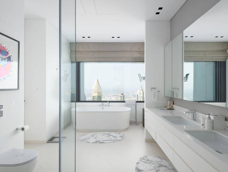 A spacious ensuite bathroom with marble finishes. Courtesy Luxhabitat Sotheby's International Realty