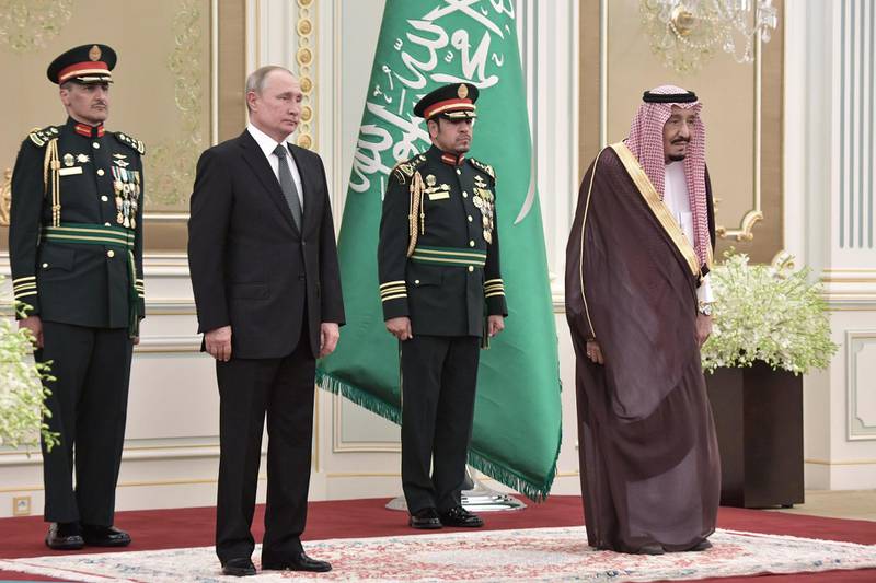 Mr. Putin and King Salman attend a welcome ceremony at the Saudi Royal palace. EPA