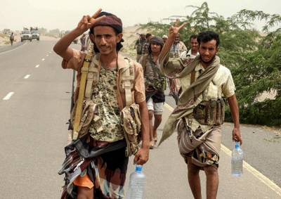 Yemeni pro-government forces flash the victory gesture as they arrive in al-Durayhimi district, about nine kilometres south of Hodeidah international airport on June 13, 2018. Yemeni forces backed by the Saudi-led coalition launched an offensive on June 13 to retake the rebel-held Red Sea port city of Hodeida, pressing toward the airport south of the city.
The port serves as the entry point for 70 percent of the impoverished country's imports as it teeters on the brink of famine. / AFP / NABIL HASSAN
