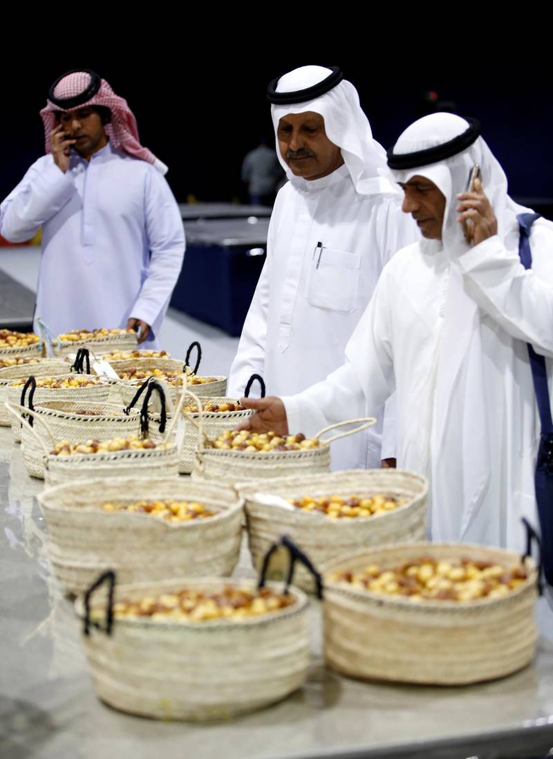 Judges inspect baskets of dates on Wednesday. EPA