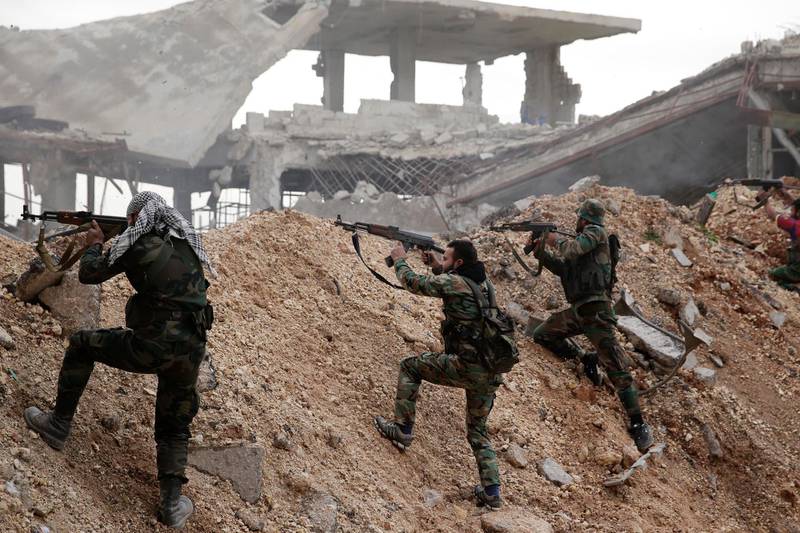 Syrian army soldiers fire their weapons during a battle with rebel fighters at the Ramouseh front line, east of Aleppo, on December 5, 2016. AP Photo