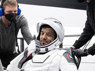 In this photo provided by NASA, United Arab Emirates astronaut Sultan al-Neyadi gestures as he is helped out of a SpaceX capsule onboard a recovery ship after he and NASA astronauts Warren "Woody" Hoburg, Stephen Bowen, and Roscosmos cosmonaut Andrei Fedyaev landed in the Atlantic Ocean off the Florida coast, Monday, Sept.  4, 2023.  The astronauts are back on Earth after a six-month stay at the International Space Station.  (Joel Kowsky / NASA via AP)