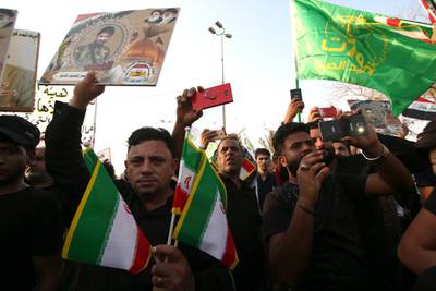 epa07023205 Supporters of Iraqi Shiite group Popular Crowd Forces carry the Iranian flag during a demonstration in Basra, southern Iraq on 15 September 2018. Dozens of Iraqis protested against the burning of the Iranian consulate and the office of Popular Crowd Forces during the protests against the government that swept Basra city last  week  EPA/HAIDER AL-ASSADEE