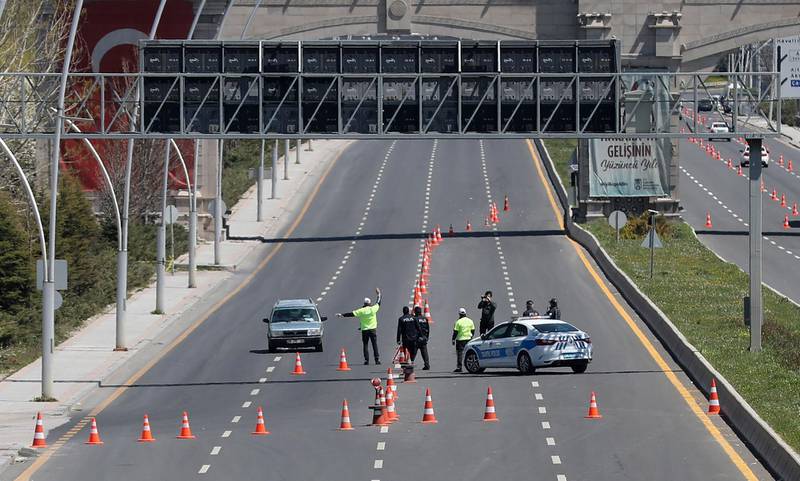 Police officers check vehicles on the empty Ataturk Airport road on the road during 48-hour restrictions imposed to stem the spread of  coronavirus in Ankara, Turkey.  AFP