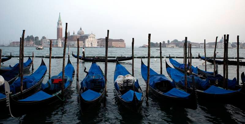 Gondolas are seen docked on the Grand Canal in Venice, Italy, on Thursday, Oct. 8, 2009. Italy needs to adopt a comprehensive strategy to boost tourism after a 7 percent decline in arrivals this summer compared with the same period last year, Confindustria said. Photographer: Giuseppe Aresu/Bloomberg