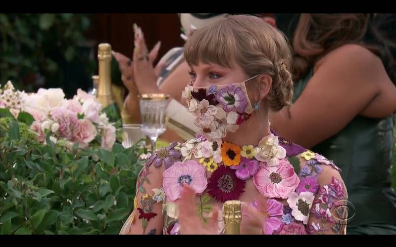 Taylor Swift paired her flowery mini dress designed by Oscar de la Renta with a matching mask. REUTERS