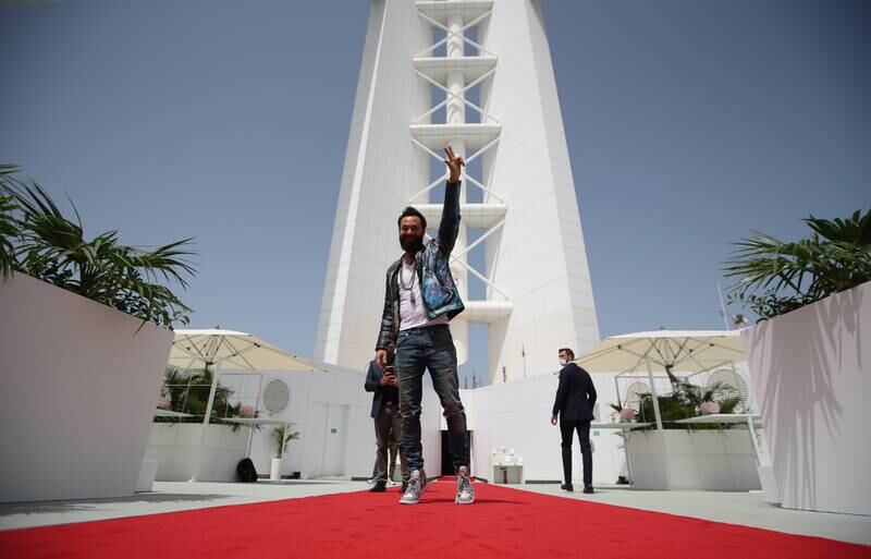 British artist and philanthropist Sacha Jafri poses at his exhibition 'The Art Maze,' which is held on the helipad of the Burj Al Arab Jumeirah in the Gulf emirate Dubai, United Arab Emirates, 23 March 2022.  The exhibit, the first of its kind on top of the luxury hotel, includes 30 oil and acrylic artworks by British artist Sacha Jafri depicting 30 World Heritage Sites and coincides with the celebration of the 50th anniversary of UNESCO's World Heritage Site program.   EPA / ALI HAIDER