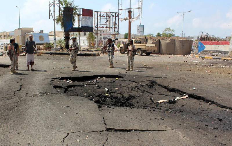 Yemeni loyalist forces gather at the scene of a suicide attack on a checkpoint near the international airport in Aden on April 17, 2016. Four Yemeni soldiers were killed in the blast. / AFP / SALEH AL-OBEIDI

